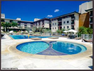a large swimming pool in front of a building at Life Resort Apt N-313 in Brasília