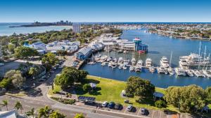 an aerial view of a marina with boats in the water at Sailport Mooloolaba Apartments in Mooloolaba