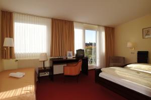 Postel nebo postele na pokoji v ubytování Hotel am Marschiertor
