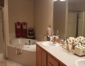 a bathroom with a sink and a bath tub at Running Y Ranch Townhouse in Klamath Falls