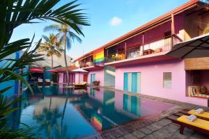 a swimming pool in front of a building with a resort at Dickman Resort "The Boutique Hotel" in Negombo