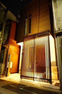 a black gate on the side of a building at 難波西villa in Osaka
