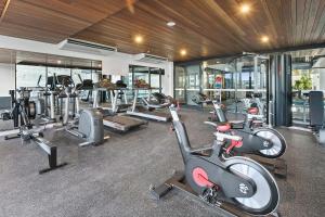 a gym with several treadmills and cardio machines at Hope Street Apartments by CLLIX in Brisbane