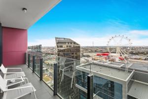 a balcony with a view of the ferris wheel at Docklands Private Collection - NEWQUAY in Melbourne