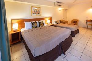 a hotel room with two beds in a room at Cairns Queens Court in Cairns