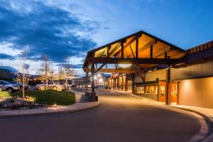 a building with a covered walkway next to a parking lot at Best Western Edgewater Resort in Sandpoint