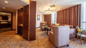 a living room with a couch and a chair at Beijing Sunflower Hotel in Tongzhou