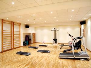 a gym with treadmills and exercise equipment in a room at Gaudi Hotel in Barcelona