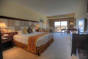 a large hotel room with a large bed and a television at Grand Hotel Excelsior in Valletta