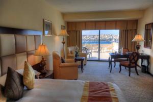 a hotel room with a bed and a living room at Grand Hotel Excelsior in Valletta