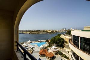 a view of the water from a balcony of a building at Grand Hotel Excelsior in Valletta