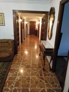 a hallway with a room with a table and a mirror at Apartamento Ciudad de la Cultura in Santiago de Compostela