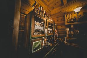 a room with a wooden wall with bottles on it at Miętowy Anioł in Ustrzyki Dolne