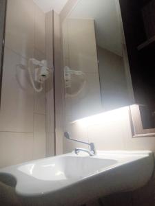 a bathroom sink with a mirror above it at U Design Hotel Bukit Mertajam in Bukit Mertajam