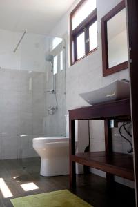 a bathroom with a sink and a toilet and a shower at Sanda Eliya Resort in Bentota