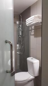 a bathroom with a toilet and a shower stall at U Design Hotel Bukit Mertajam in Bukit Mertajam
