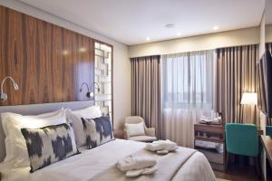 
Uma cama ou camas num quarto em TURIM Saldanha Hotel
