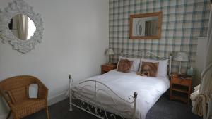 A bed or beds in a room at The Willows 