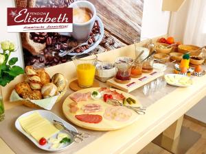 a breakfast table with food and drinks on it at Pension Elisabeth in Todtnauberg