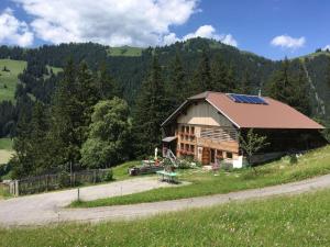 a house with solar panels on the side of a road at Giferspitz Gstaad in Gstaad