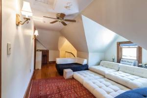 a living room with a couch and a ceiling fan at Charming Harvard Victorian in Cambridge