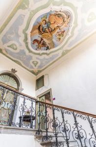 a staircase with a painting on the ceiling at Villa De Rubeis Florit in Tarcento