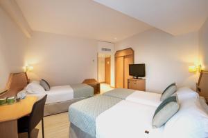 Postel nebo postele na pokoji v ubytování Hotel Praga