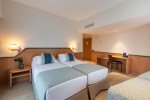 Postel nebo postele na pokoji v ubytování Hotel Praga