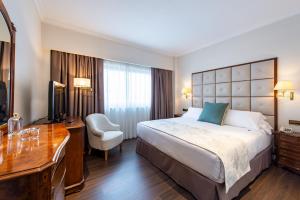 Postel nebo postele na pokoji v ubytování Hotel Praga