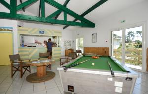 a room with a pool table and a bar at Résidence Odalys Bleu Ocean in Moliets-et-Maa