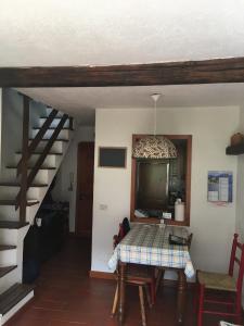 a dining room with a table and a staircase at Condominio Colmet in La Thuile