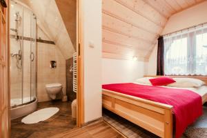 a bedroom with a large bed and a shower at Willa Trebunia in Zakopane