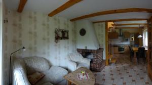 a living room with a couch and a fireplace at Eule ost und west Ferienhaus im urigen Garten in Zingst