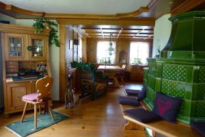 a large room with a kitchen and a dining room at Hollhouse - Bed & Breakfast in Hinterzarten