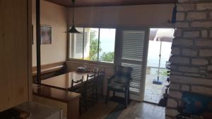 a kitchen with a table and chairs and a window at Heavenly House by the sea in Savudrija