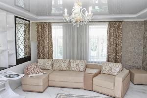 a living room with a couch and two chairs and a chandelier at Apartment on Malaya Troitskaya 13 in Grodno