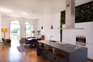 a kitchen with a counter and a dining room at Wonderful balcony over Clérigos Tower in Porto