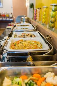 a buffet line with many trays of food at Asoke Residence Sukhumvit by UHG in Bangkok +82 photos