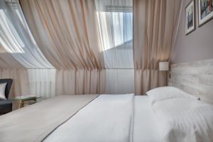 a bedroom with a white bed and a window at Hotel Florenc in Prague