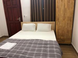 Postel nebo postele na pokoji v ubytování An Ngọc Linh Hotel