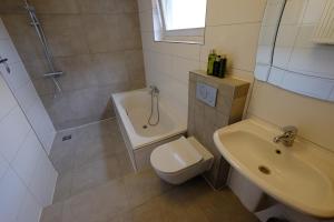 a bathroom with a shower and a toilet and a sink at Citycenter Residence in Amsterdam +11 photos