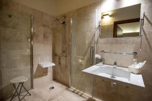 ein Bad mit einer Dusche, einem Waschbecken und einer Dusche in der Unterkunft Hotel Flora in Cagliari