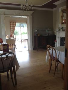 a kitchen and dining room with a table and chairs at Deerpark Manor Bed and Breakfast in Swinford