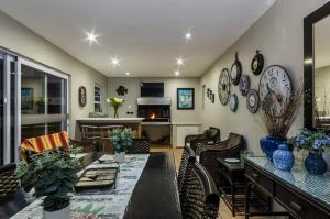 a living room with a table and chairs at Abalone Guest House in Port Elizabeth