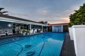 a swimming pool in the backyard of a house at Abalone Guest House in Port Elizabeth