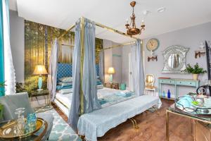 a bedroom with a four poster bed with blue drapes at Mama’s Inn Boutique Guest House in Nottingham