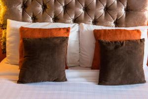 
two white pillows sitting on top of a bed at The White Hart Inn in Llandeilo
