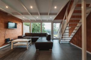 a living room with a couch and a table at Terrasses de Malmedy Chalet 113 in Malmedy