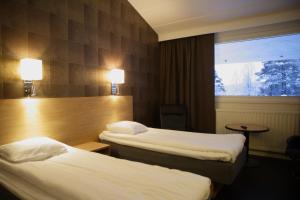 Postel nebo postele na pokoji v ubytování Laponia Hotell & Konferens