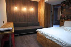 a hotel room with a bed and a couch at Brick Lane Studios in London
